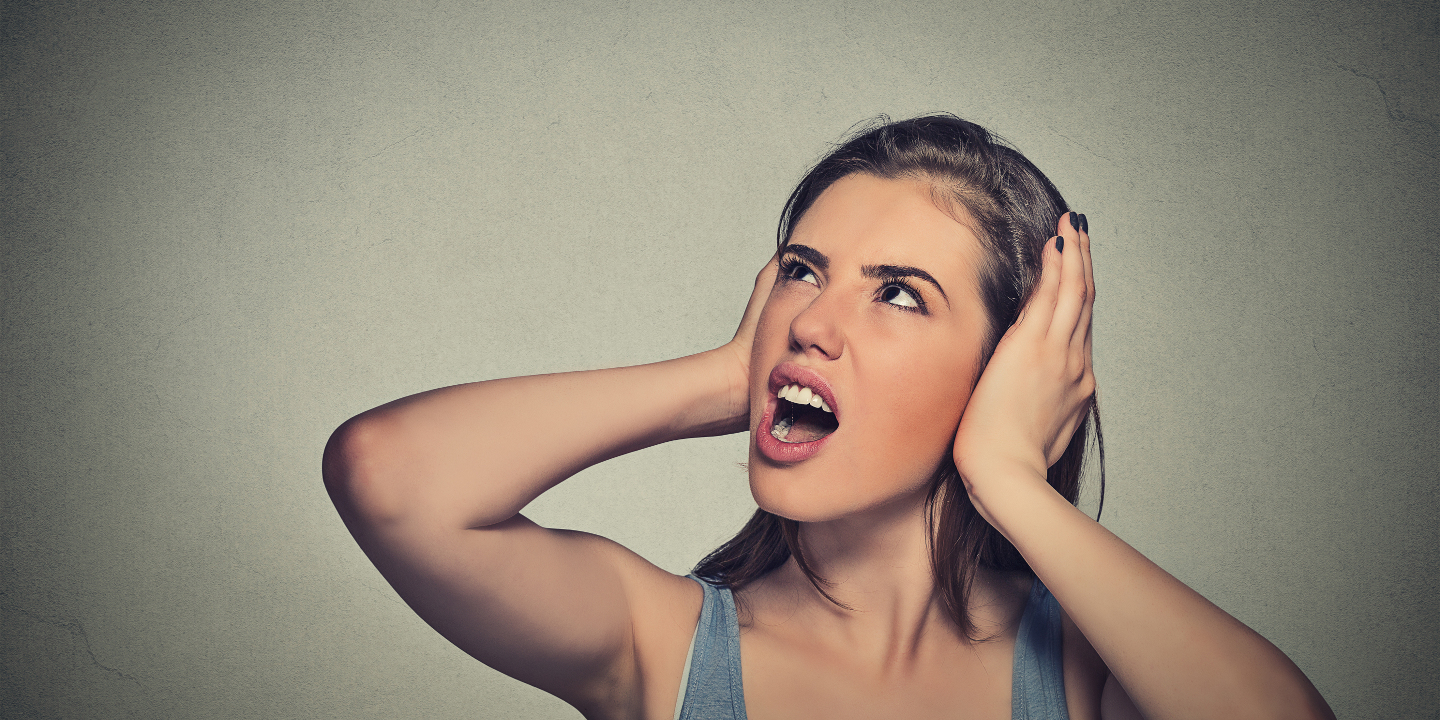 Woman unhappy covering ears